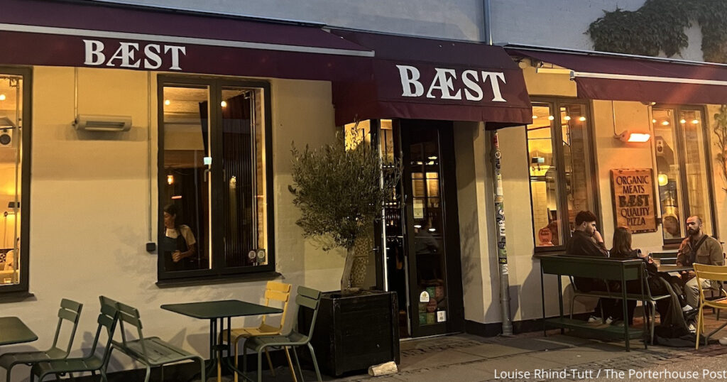 The exterior of Baest restaurant with a burgundy awning